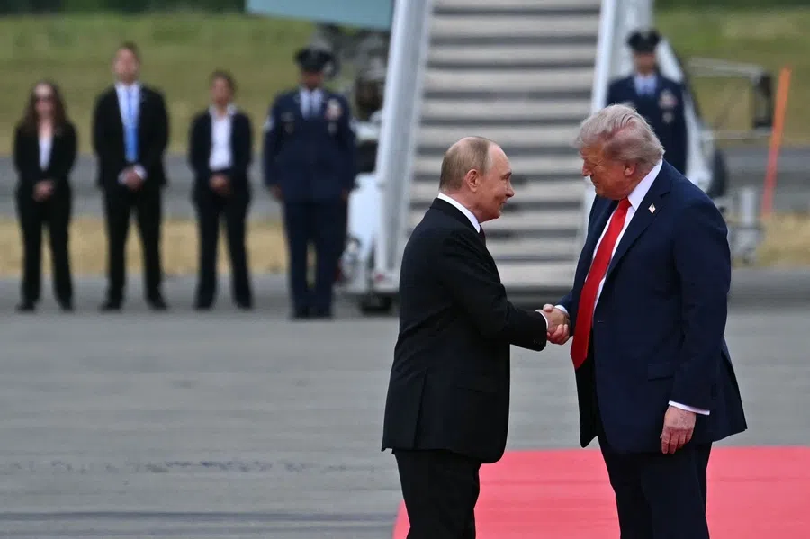 US President Donald Trump shakes hands with Russian President Vladimir Putin on the tarmac after they arrived at Joint Base Elmendorf-Richardson in Anchorage, Alaska, on 15 August 2025. (Handout/Ukrainian Presidential Press Service/AFP)