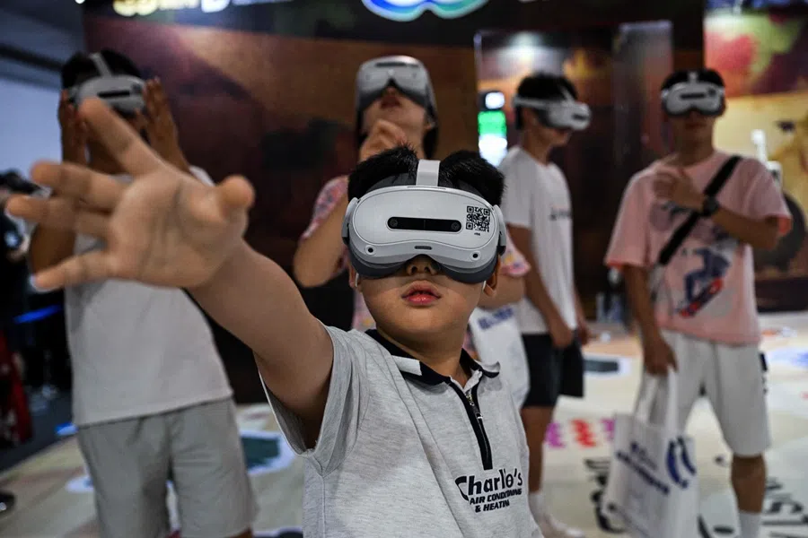 People use augmented reality headsets during the World Artificial Intelligence Conference (WAIC) at the Shanghai World Expo and Convention Center in Shanghai on 28 July 2025.