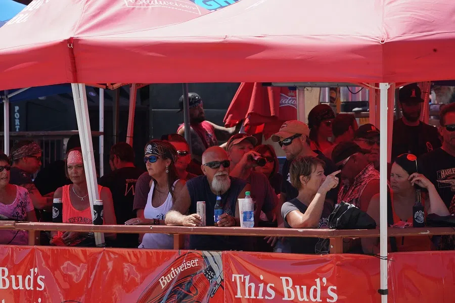 People gather for drinks under a tent on Main Street during the 80th Annual Sturgis Motorcycle Rally on 8 August 2020 in Sturgis, South Dakota. (Bryan R. Smith/AFP)