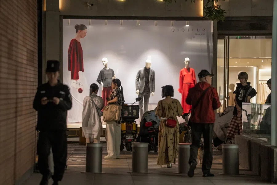 Pedestrians in front of a store in Beijing, China, on 1 May 2025. (Na Bian/Bloomberg)