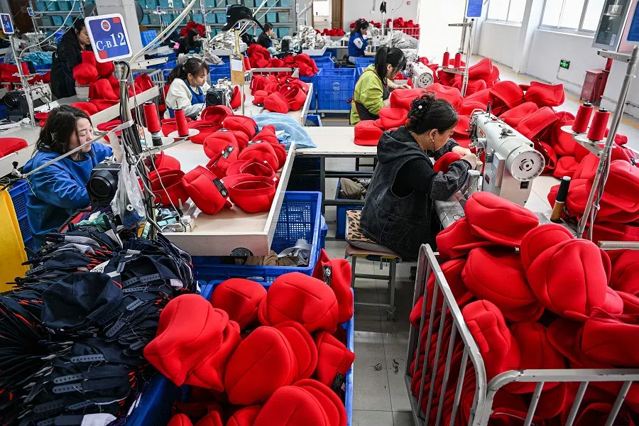 Employees work on a production line of caps that will be exported to the US at a factory in Suqian, in eastern China’s Jiangsu province on 7 April 2025. (AFP)