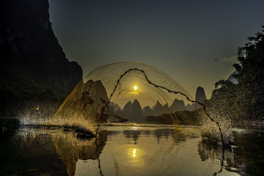 A retired Cormorant fisherman on the river Li, who now earns a living from demonstrating his skills to the many tourists visiting Guilin and the surrounding areas. Humans are both a part of nature, and separate from it. (iStock)