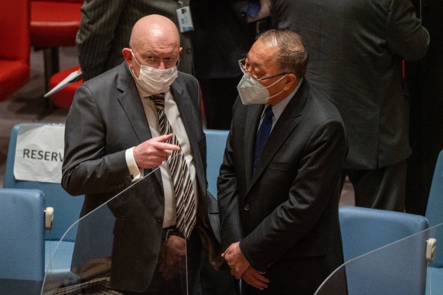 Vasily Nebenzya (left), Permanent Representative of Russia to the United Nations, speaks to Zhang Jun (right), Permanent Representative of China to the United Nations, prior to the United Nations Security Council's emergency meeting to discuss the threat of a full-scale invasion by Russia of Ukraine on 23 February 2022 in New York City, US. (David Dee Delgado/Getty Images/AFP)
