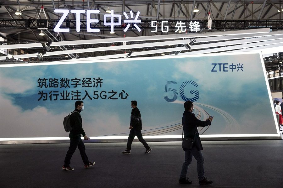 Attendees walk past signage for 5G at the ZTE Corp. booth at the MWC Shanghai exhibition in Shanghai, China, on 23 February 2021. (Qilai Shen/Bloomberg)