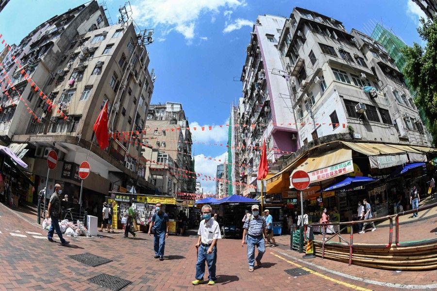 This picture taken with a fisheye lens shows people shopping in Hong Kong on 5 October 2021. (Peter Parks/AFP)