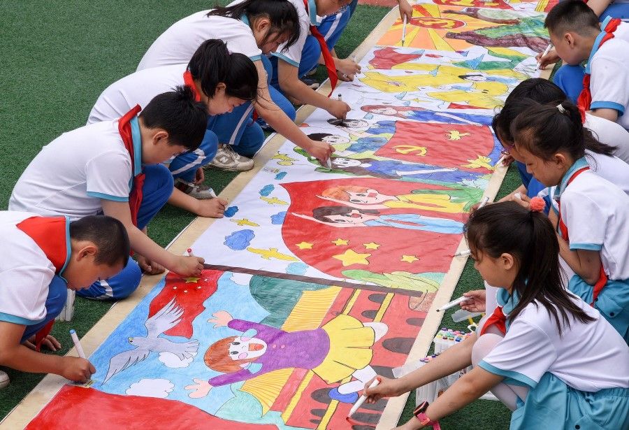 Elementary school students draw a picture on International Children's Day in Handan in China's northern Hebei province on 1 June 2021. (STR/AFP)