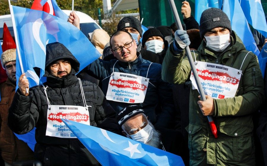 People from China's Uighur Muslim ethnic group protest outside the city's Turkish Olympic Committee building, calling for a boycott of the Winter Olympics in Beijing over China's treatment of the minority, in Istanbul, Turkey, 23 January 2022. (Umit Bektas/Reuters)