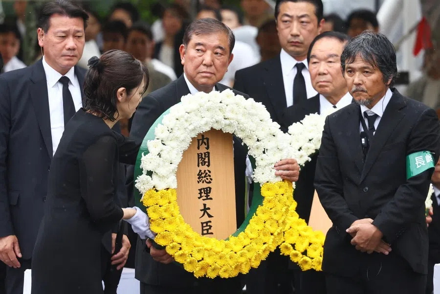 Japan’s Prime Minister Shigeru Ishiba offers a flower wreath for the victims of the 1945 atomic bombing, during a ceremony commemorating the 80th anniversary of the bombing of the city, at Nagasaki’s Peace Park in Nagasaki, southwestern Japan, on 9 August 2025.