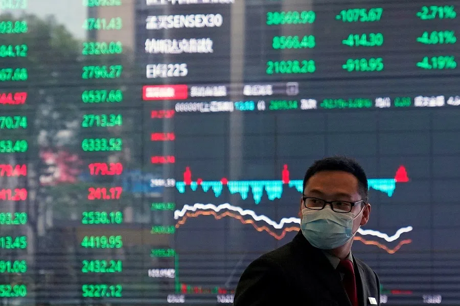 A man wearing a protective mask is seen inside the Shanghai Stock Exchange building, as the country is hit by the Covid-19 pandemic, at the Pudong financial district in Shanghai, China on 28 February 2020. (Aly Song/Reuters)