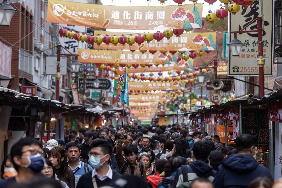 People visit Dihua Street in Taipei, Taiwan, on 4 February 2024. (I-Hwa Cheng/AFP)