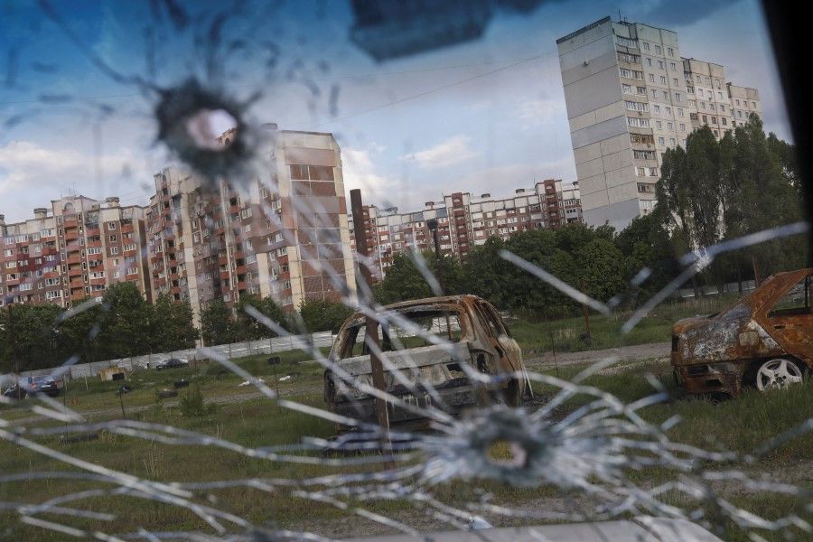 Burnt cars are pictured through the glass of a damaged car in Saltivka neighbourhood, amid Russia's attack on Ukraine, in Kharkiv, Ukraine, 10 May 2022. (Ricardo Moraes/Reuters)