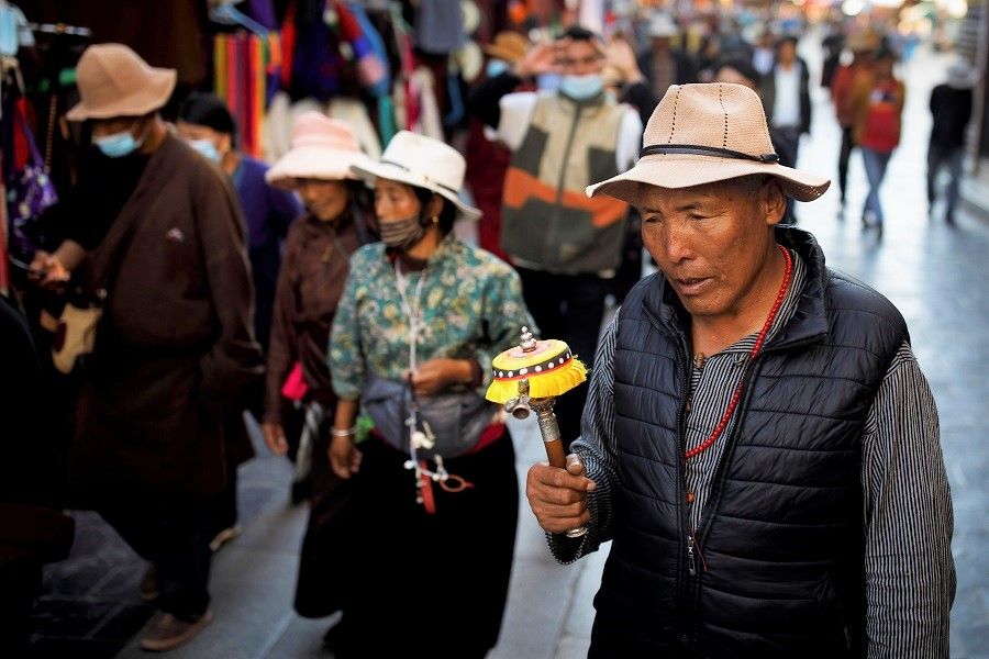 Tibetans perform a pilgrimage around the Jokhang Temple in Lhasa, Tibet Autonomous Region, China, 15 October 2020. (Thomas Peter/Reuters)