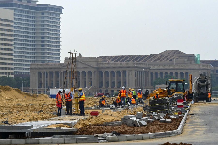 Labourers work at the construction site on reclaimed land as part of the Chinese-funded project for Port City, in Colombo, Sri Lanka, on 28 October 2021. (Ishara S. Kodikara/AFP)