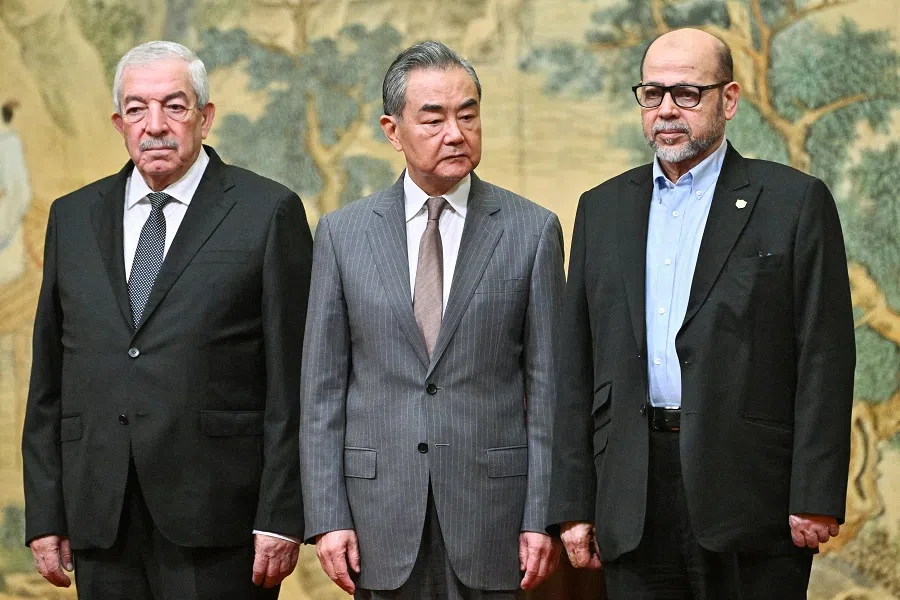 Mahmoud al-Aloul, vice-chairman of the Central Committee of Palestinian organisation and political party Fatah, China’s Foreign Minister Wang Yi, and Mussa Abu Marzuk, senior member of the Palestinian Islamist movement Hamas, attend an event at the Diaoyutai State Guesthouse in Beijing on 23 July 2024.