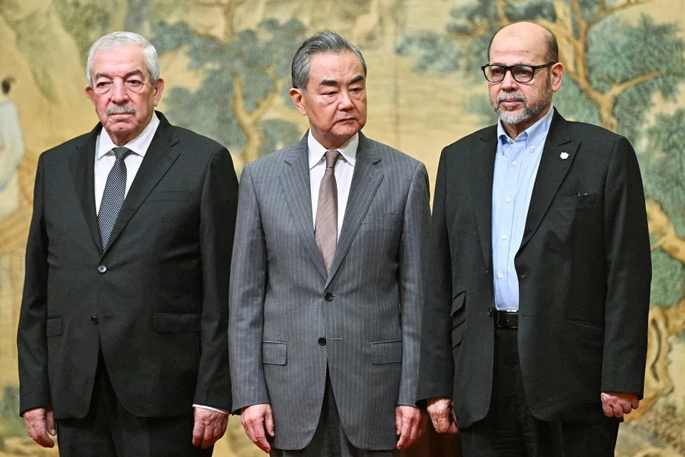 Mahmoud al-Aloul, vice-chairman of the Central Committee of Palestinian organisation and political party Fatah, China’s Foreign Minister Wang Yi, and Mussa Abu Marzuk, senior member of the Palestinian Islamist movement Hamas, attend an event at the Diaoyutai State Guesthouse in Beijing on 23 July 2024. (Pedro Pardo/Pool via Reuters)