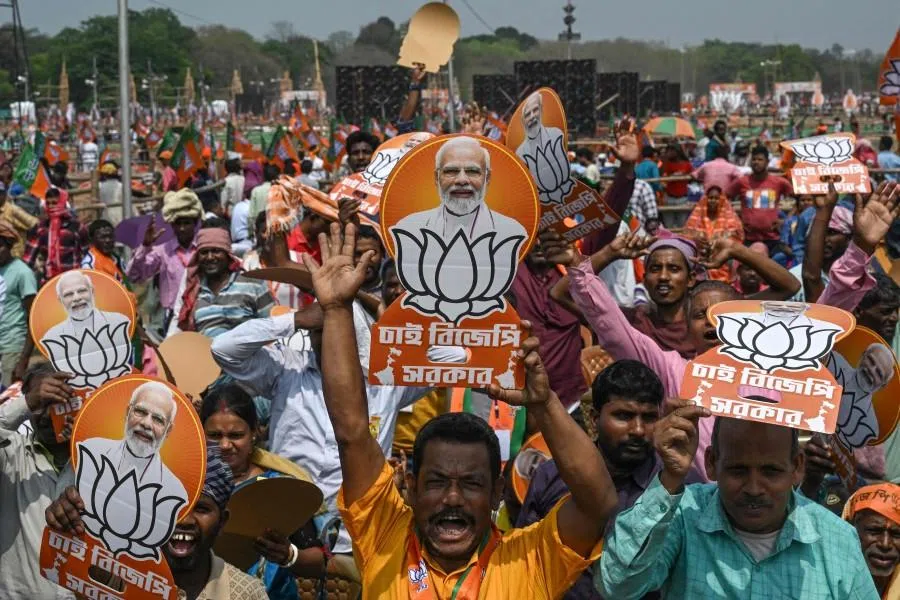 Bharatiya Janata Party (BJP) supporters holding posters of India’s Prime Minister Narendra Modi attend a mass rally in Kolkata on 14 March 2026. (Dibyangshu Sarkar/AFP)