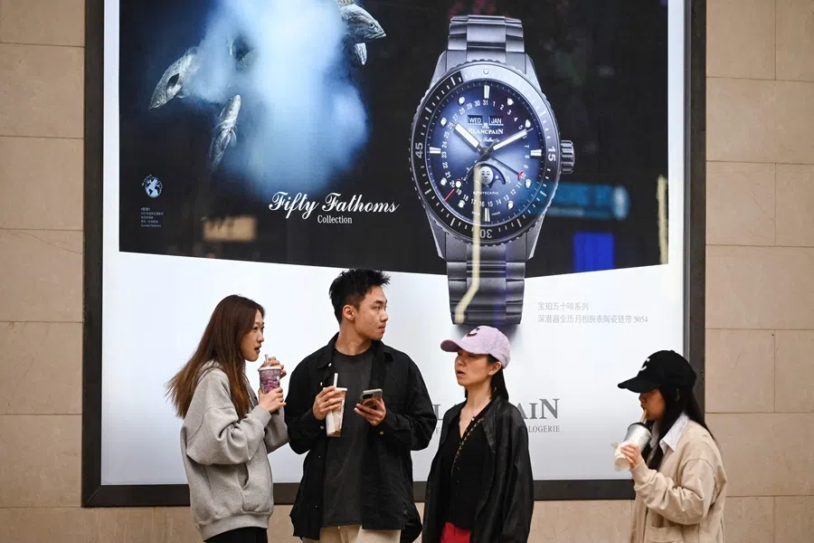 People outside a watch store in Beijing, China on 5 May 2025. (Greg Baker/AFP)