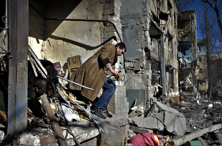 A local resident looks for his belongings after shelling in Kramatorsk, Ukraine, on 14 March 2023, amid the Russian invasion of Ukraine. (Sergey Shestak/AFP)