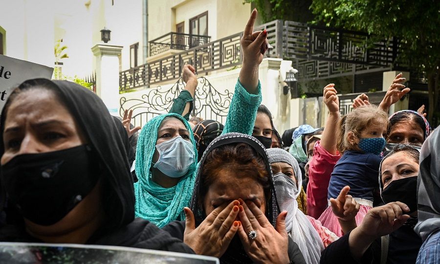 Afghans residing in India take part in a demonstration outside the United Nations High Commissioner for Refugees (UNHCR) office in New Delhi, India on 23 August 2021 to protest against the Taliban's military takeover of Afghanistan. (Sajjad Hussain/AFP)