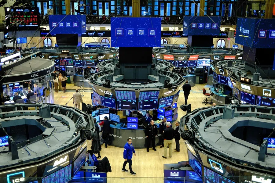 Traders work on the floor of the New York Stock Exchange (NYSE) at the opening bell in New York on 16 December 2025. (Charly Triballeau/AFP)