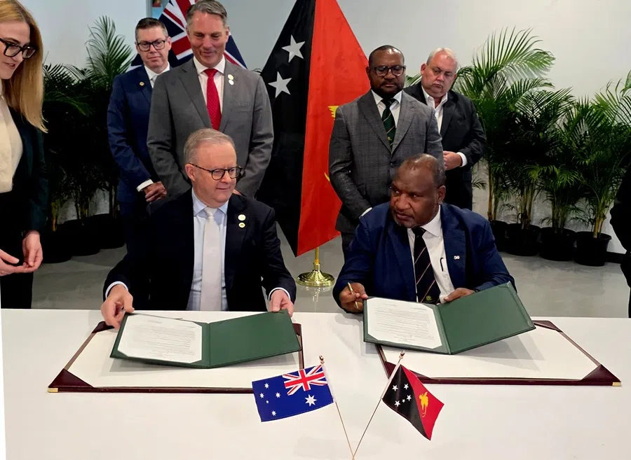 Papua New Guinea's Prime Minister James Marape (right) and his Australian counterpart Anthony Albanese sign a mutual communique in Port Moresby on 17 September 2025. (AFP)
