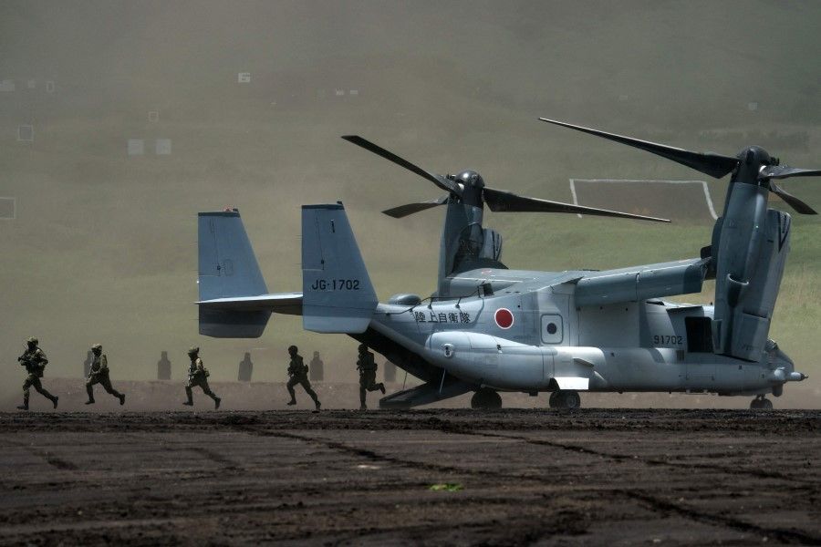 Members of the Japan Ground Self-Defense Force (JGSDF) disembark from a V-22 Osprey aircraft during a live fire exercise at East Fuji Maneuver Area in Gotemba on 28 May 2022. (Tomohiro Ohsumi/AFP)