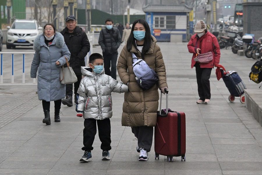 People walk on a street in Beijing, China, on 17 January 2024. (Pedro Pardo/AFP)