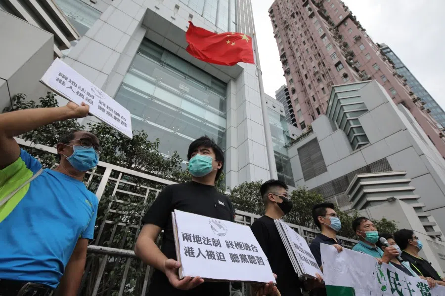 Members of the Democratic Party hold signs during a protest in front of the Liaison Office of the Central People's Government in Hong Kong, 22 May 2020. Democracy advocates called for protests against sweeping national security legislation China introduced Friday, as authorities in Beijing vowed to end what they called a "defenseless" posture due to "those trying to sow trouble." (Paul Yeung/Bloomberg)