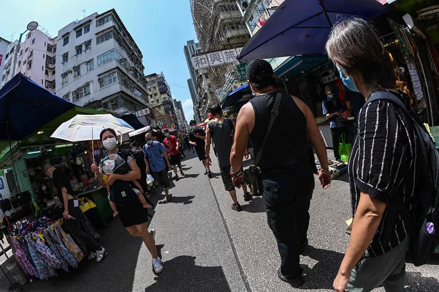 This picture taken with a fisheye lens shows people shopping in Hong Kong on 5 October 2021. (Peter Parks/AFP)