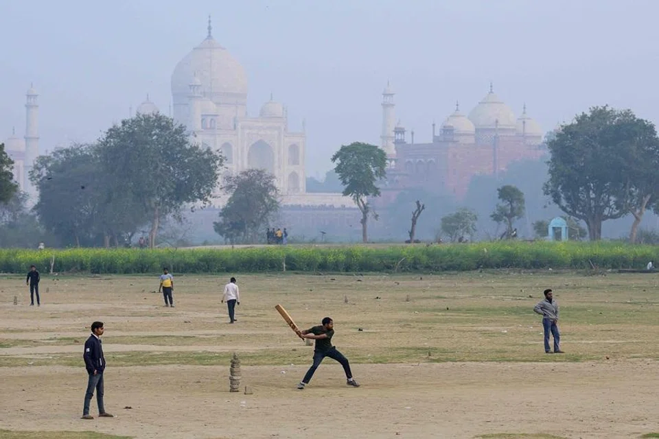 In this photograph taken on 31 January 2026, cricket enthusiasts play on a field near the Taj Mahal in Agra, India. (Manan Vatsyayana/AFP)