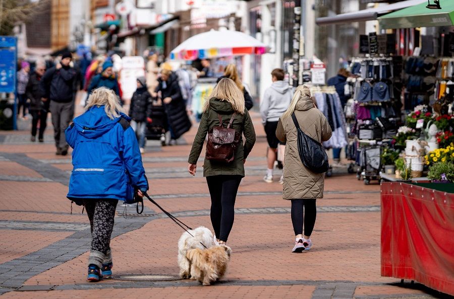 People walk along a shopping street in Eckernförde, Germany, on 14 April 2021. (Axel Heimken/AFP)