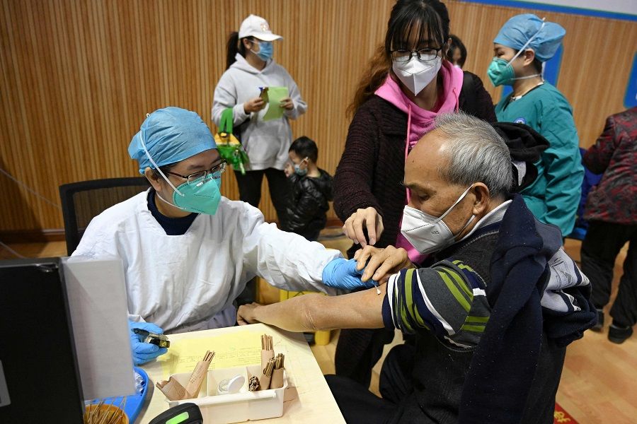 A resident receives a Covid-19 vaccine in Guangzhou, Guangdong province, China, on 6 December 2022. (CNS/AFP)