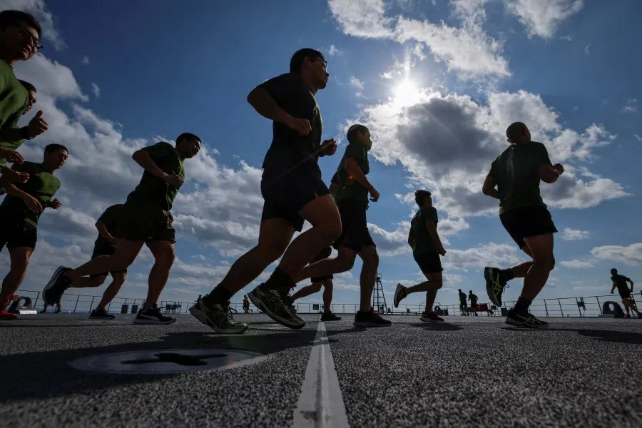Japanese Ground Self-Defense Force's Amphibious Rapid Deployment Brigade (ARDB) soldiers train on the flight deck of the Japanese Maritime Self-Defense Force's amphibious transport ship JS Shimokita (LST-4002) in waters close to Tokunoshima Island, Japan, on 16 November 2023. (Issei Kato/Reuters)
