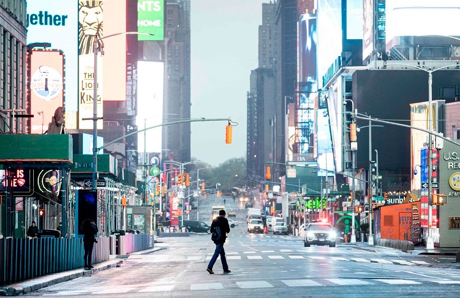 A man crosses the street at Times Square amid the Covid-19 pandemic on 30 April 2020 in New York City. (Johannes Eisele/AFP)