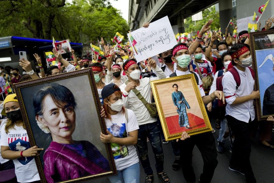 Myanmar migrant workers demonstrate against the military coup and demand the restoration of democracy in their country during a protest to mark May Day, in Bangkok, Thailand, 1 May 2022. (Soe Zeya Tun/Reuters)