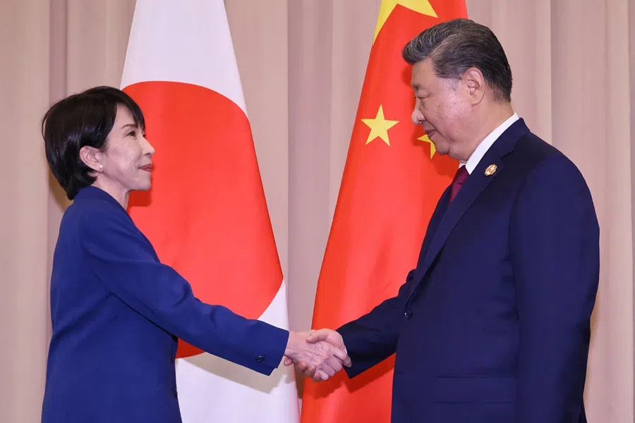 Japan's Prime Minister Sanae Takaichi (L) shakes hands with Chinese President Xi Jinping ahead of the Japan-China summit on the sidelines of the Asia-Pacific Economic Cooperation (APEC) Summit in Gyeongju on 31 October 2025. (Japan Pool/Jiji Press/AFP)