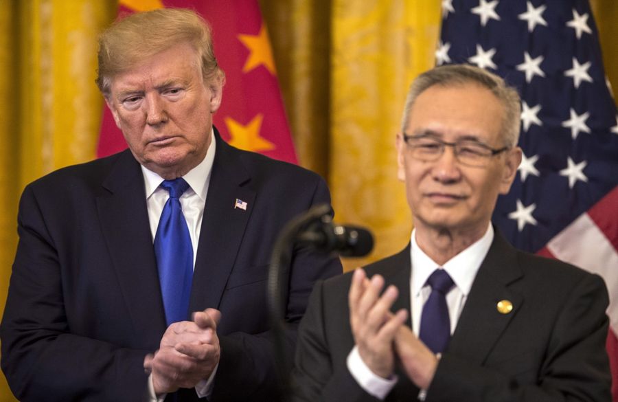 US President Donald Trump applauds as Liu He, China's vice premier, speaks during a signing ceremony for the US-China phase-one trade agreement in Washington on 15 January 2020. (Zach Gibson/Bloomberg)
