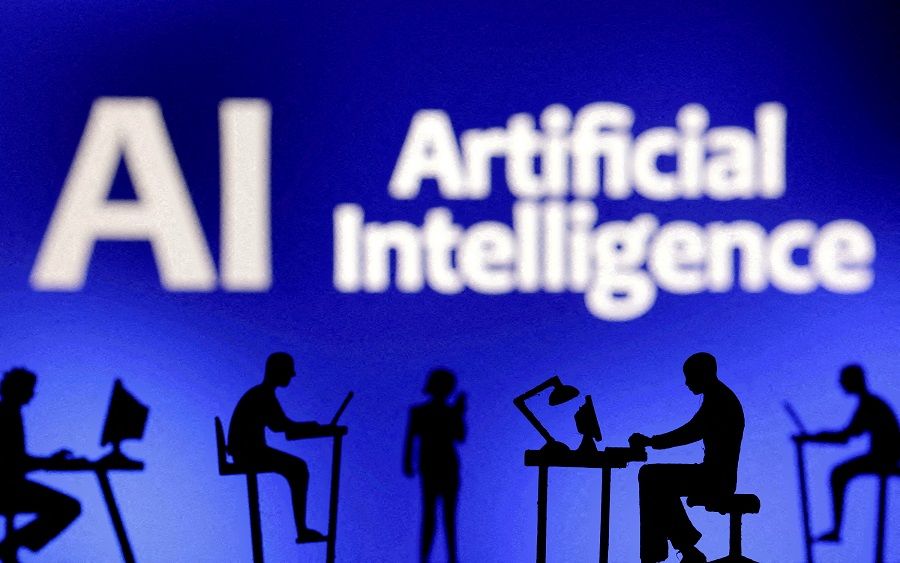 Figurines with computers and smartphones are seen in front of the words "Artificial Intelligence AI" in this illustration taken 19 February 2024. (Dado Ruvic/Illustration/Reuters)