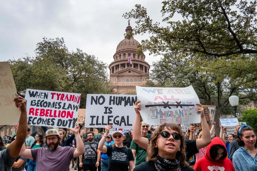 People prepare to march while protesting against US President Donald Trump during a demonstration at the Texas State Capitol on 5 February 2025 in Austin, Texas. People all over the country rallied at their state capitols during a day of protest against US President Donald Trump and the political initiative Project 2025. Demonstrators spoke out against the Trump administration and various newly introduced policies involving, immigration, the removal of diversity initiatives, and the potential accessing of private information involving Elon Musk’s DOGE (Department of Government Efficiency) programme. (Brandon Bell/Getty Images via AFP )