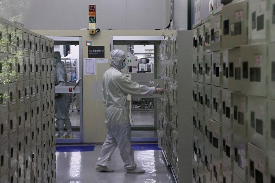 A member of staff approaches a locker at a lab at the Taiwan Semiconductor Research Institute at Hsinchu Science Park in Hsinchu, Taiwan, 16 September 2022. (Ann Wang/Reuters)