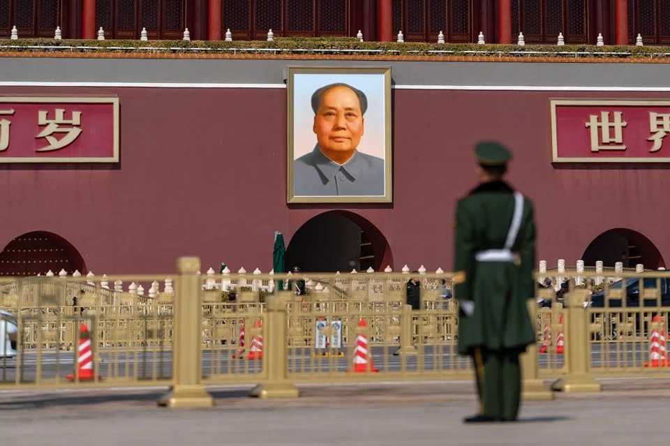 A member of the People's Liberation Army in front of a portrait of former Chinese leader Mao Zedong at Tiananmen Square ahead of the closing of the Second Session of the 14th National People's Congress in Beijing, China, on 11 March 2024. (Bloomberg)