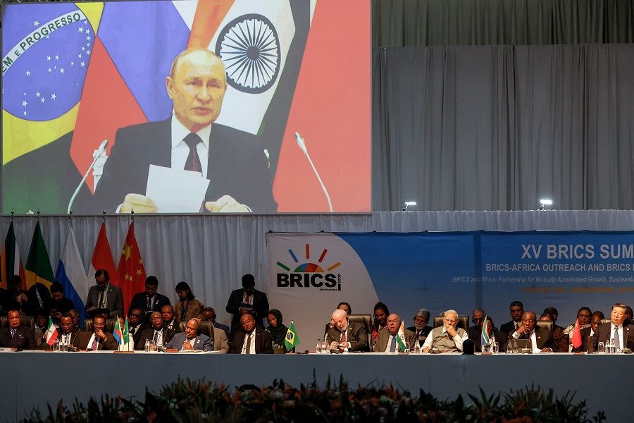A screen shows Russian President Vladimir Putin virtually delivering remarks at a meeting during the 2023 BRICS Summit in Johannesburg, South Africa, on 24 August 2023. (Marco Longari/Pool/AFP)