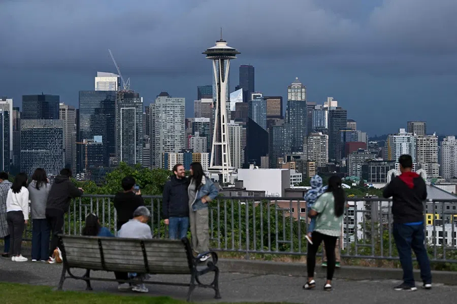 People gather at Kerry Park to see the Space Needle at dusk in Seattle, Washington, on 21 June 2025. (Juan Mabromata/AFP)