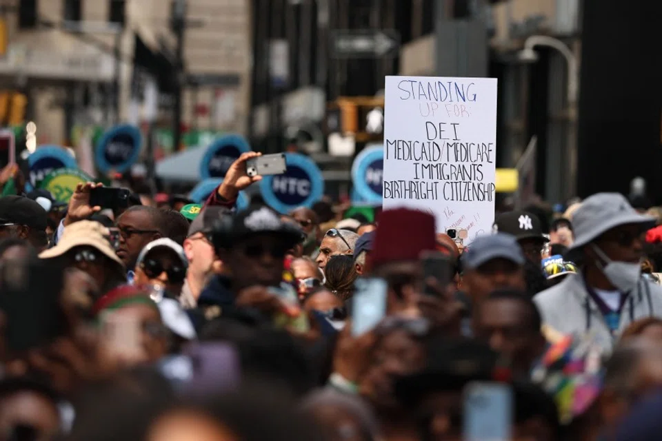 People participate in the March on Wall Street on 28 August 2025 in New York City. Rev. Al Sharpton and National Action Network (NAN) lead a protest march on Wall Street, which began at Foley Square, to urge corporate America to resist the Trump administration’s campaign to roll back diversity, equity and inclusion (DEI) initiatives. The march comes on the anniversary of the Civil Rights-era March on Washington in 1963. (Michael M. Santiago/AFP)