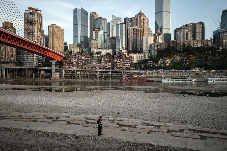 An exposed riverbed, due to low water levels caused by drought, along the Jialing River near the confluence with the Yangtze River in Chongqing, China, on 17 August 2022. (Qilai Shen/Bloomberg)