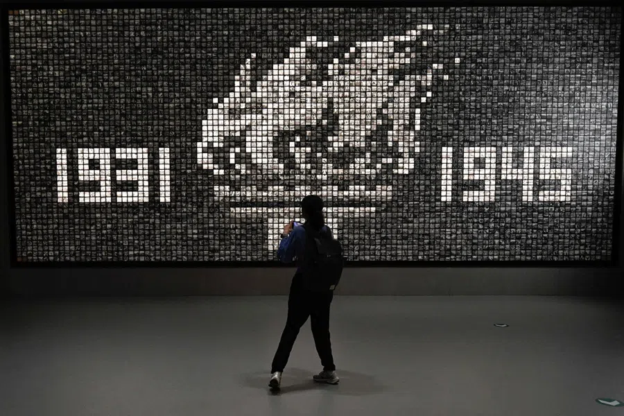 A woman looks at an installation as she visits an exhibition commemorating the 80th anniversary of the victory over Japan and the end of World War II at the Museum of the War of Chinese People’s Resistance Against Japanese Aggression in Beijing on 27 August 2025. (Wang Zhao/AFP)