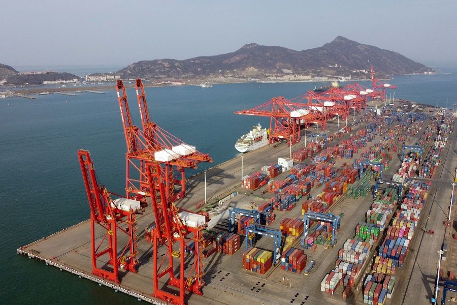 An aerial picture shows container cranes and containers at the Lianyungang Port Container Terminal in Lianyungang, Jiangsu province, China on 24 March 2021. (Hector Retamal/AFP)