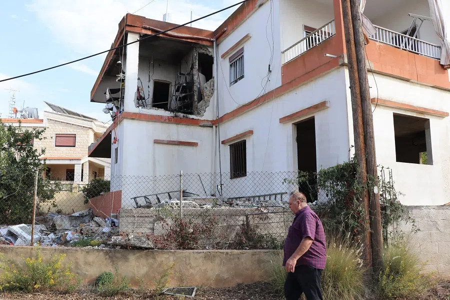 A man inspects the damage to a house in the village of Alma al-Shaab, close to the southern Lebanese border with Israel on 30 October 2023, amid the ongoing battles between Israel and the Palestinian group Hamas in the Gaza Strip. (AFP)