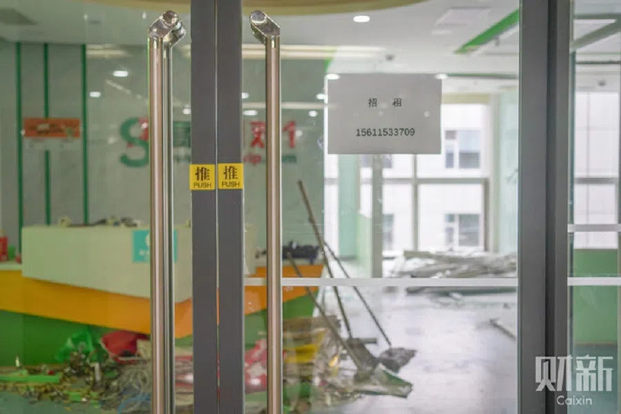 A notice seeking new tenant is posted on the front door of the closed Gaosi Education premise at the E-wing Center in Beijing, China. (Zhang Ruixue/Caixin)