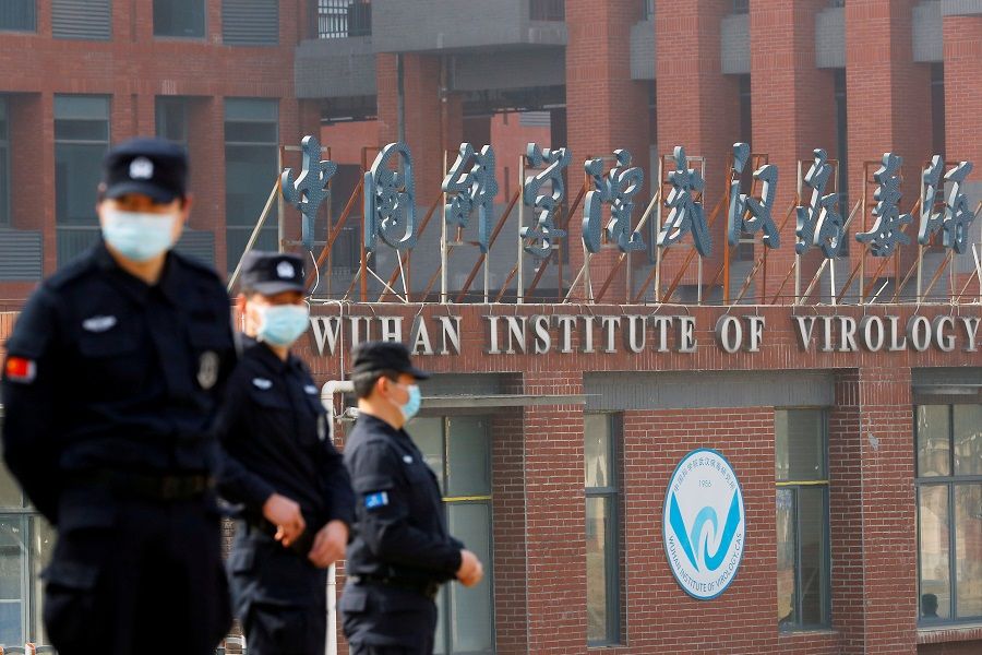 Security personnel keep watch outside the Wuhan Institute of Virology during the visit by the World Health Organization (WHO) team tasked with investigating the origins of the Covid-19 coronavirus, in Wuhan, Hubei province, China, 3 February 2021. (Thomas Peter/File Photo/Reuters)